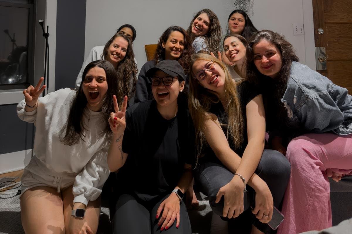 The DG Girls group gathered together in a living room